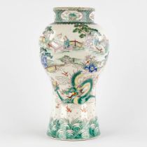 A Oriental vase, Famille Verte decorated with a dragon and figurines. (H:36 x D:21 cm)