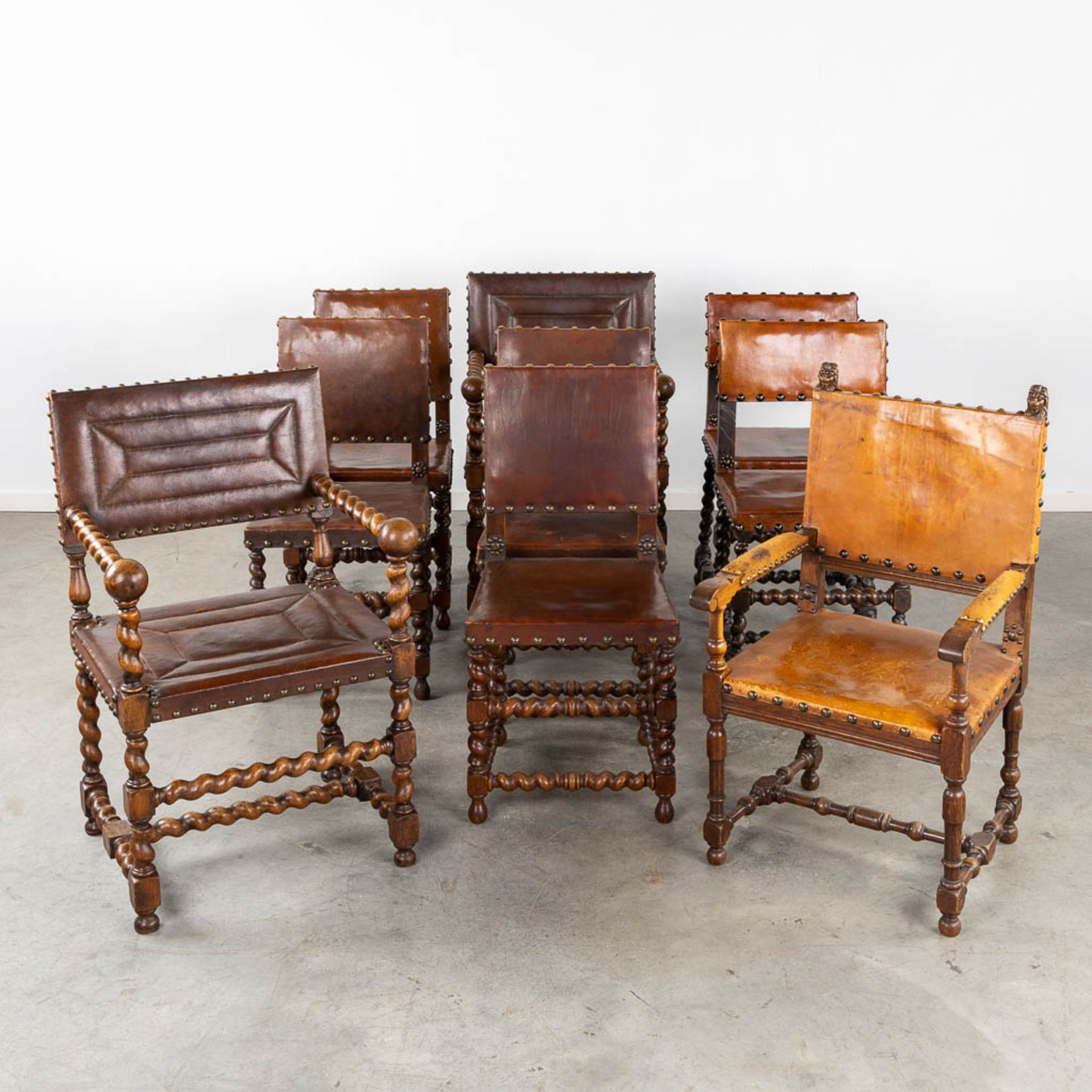 An assembled collection of chairs and armchairs, wood and leather. 9 pieces. (L:56 x W:59 x H:94 cm)