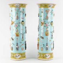 A pair of Chinese vases with a turquoise ground relief decor of antiquities and symbols of happiness