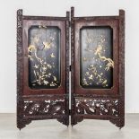 An Oriental two-piece folding screen, sculptured wood decorated with fauna and flora. (W:172 x H:182