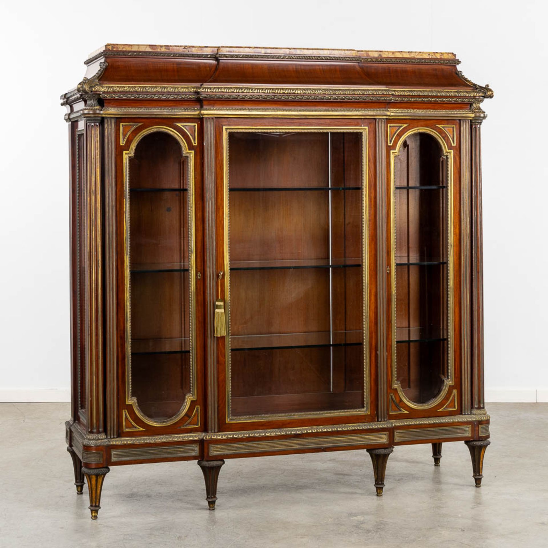 An exceptional display cabinet, richly mounted with bronze and a Breche D'alep marble top. Circa 188