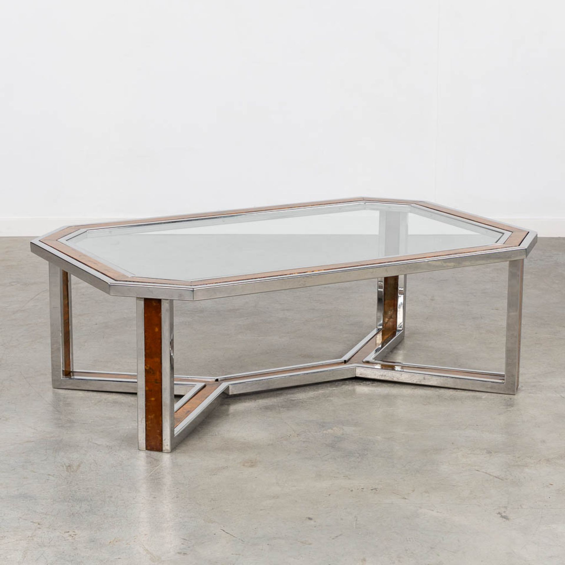 A coffee table, chrome with a faux wood inlay and a glass top. (L:80 x W:120 x H:40 cm)