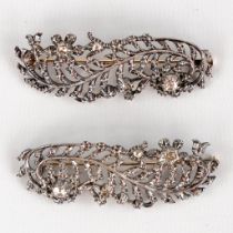 A pair of antique brooches, silver with a 14-karat gold locking mechanism, old cut diamonds. (W:5,9