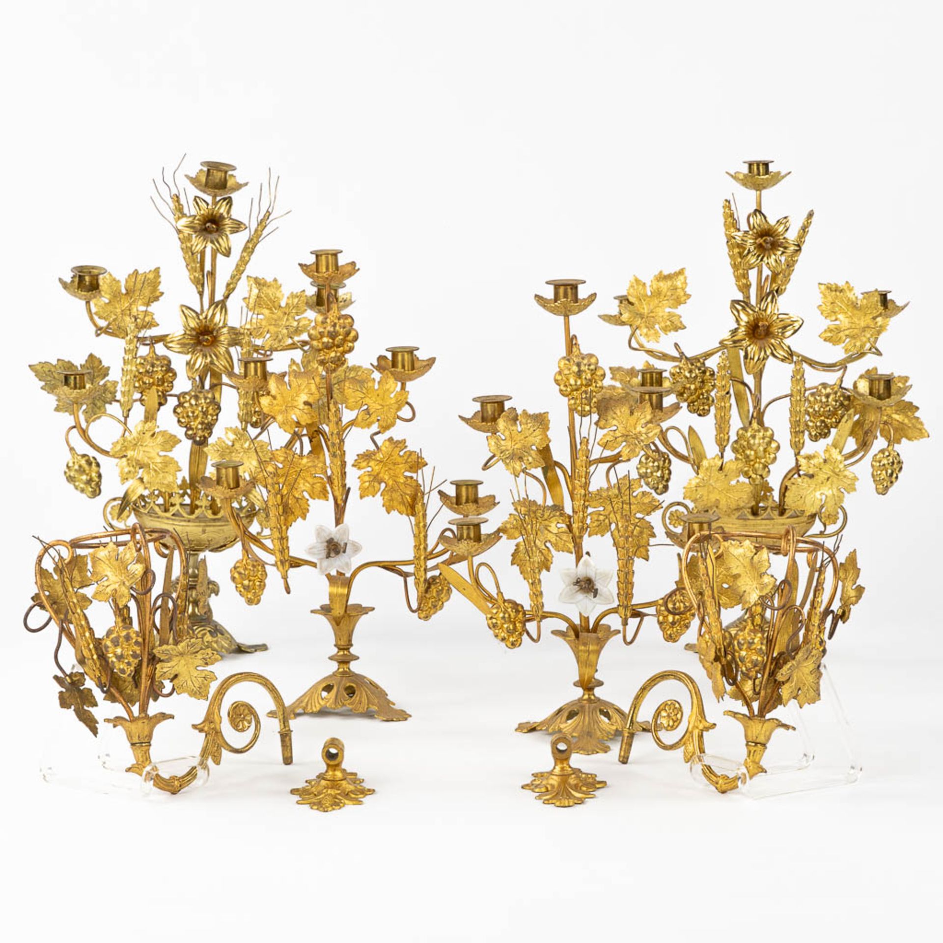 Two pairs of Church Candelabra and a pair of wall-mounted candelabra, Gilt metal decorated with whea