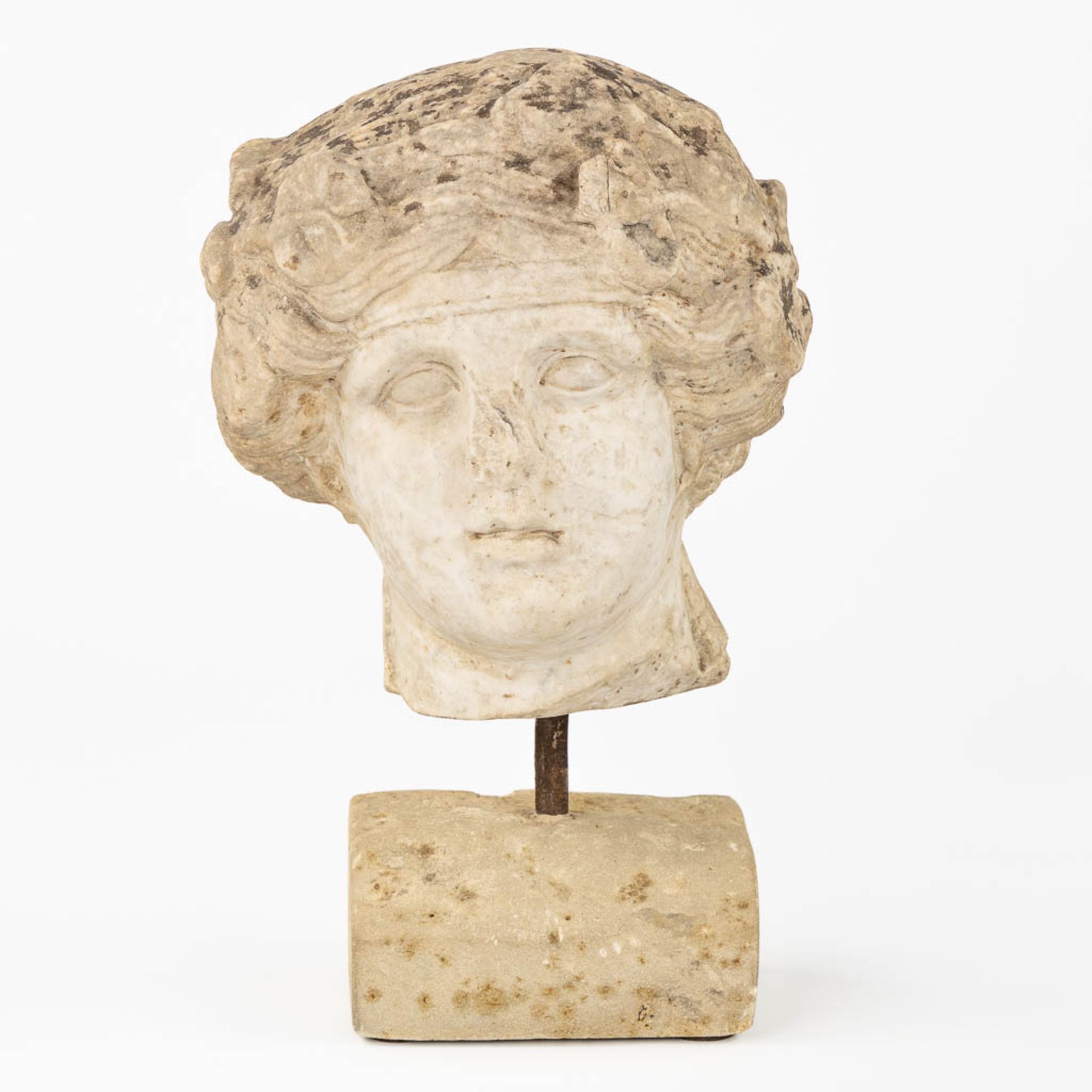 An antique sculptured head of a lady, mounted on a base. Probably of Roman origin. (L:25 x W:24 x H: