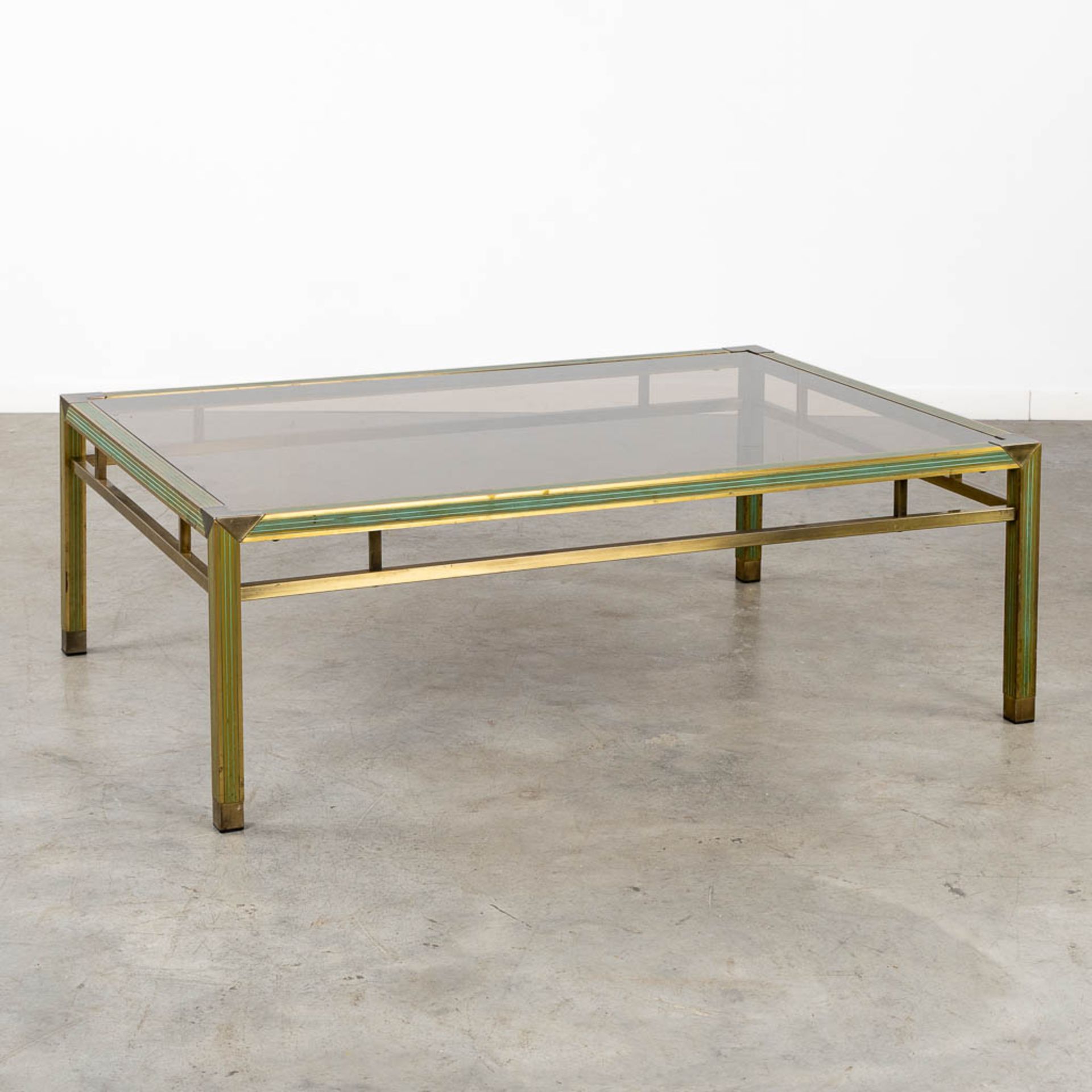 A mid-century coffee table, brass and glass in the style of Belgo Chrome. (L:88 x W:128 x H:43 cm)