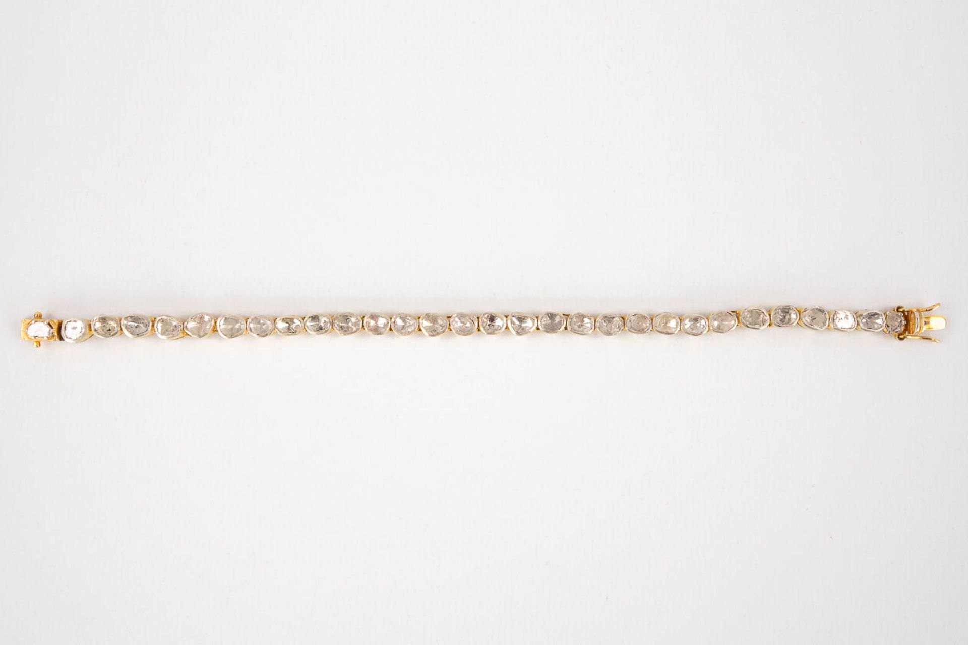 A bracelet with rough cut and flat top diamonds, in silver holders, gilt silver. 19,51g. (L:19,6 cm) - Image 4 of 12