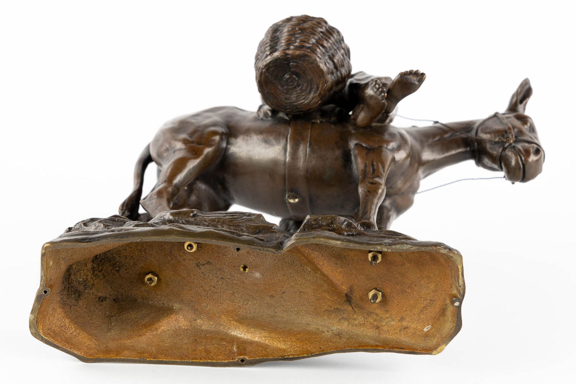 A small figurine of a young man riding a donkey, patinated bronze. Circa 1900. (L:18 x W:28 x H:33 c - Image 7 of 10