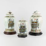 A pair of Chinese baluster vases and a ginger jar, Famille Rose decorated with bonsai. 19th/20th C.