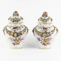 A pair of porcelain vases with hand-painted and relief flower decor. (H:32 x D:23 cm)