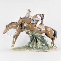 Lladro 'Derby' , a polychrome porcelain group of jumping horses. (L:51 x W:23 x H:40 cm)