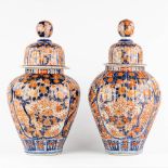A near pair of antique Japanese Imari vases with a lid. 19th/20th C. (H:53 x D:27 cm)