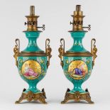 A pair of oil lamps, hand-painted decors with 'Bacchanale scnes' and mounted with bronze. 19th C. (