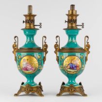 A pair of oil lamps, hand-painted decors with 'Bacchanale scnes' and mounted with bronze. 19th C. (