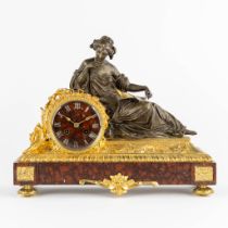 A mantle clock, decorated with a lying lady. Red marble, gilt and patinated bronze. Carpentier, Pari