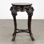 A richly sculptured Chinese hardwood side table or pedestal with a marble. (H:71 x D:53 cm)