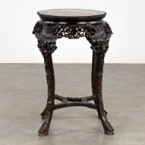 A richly sculptured Chinese hardwood side table or pedestal with a marble. (H:71 x D:53 cm)