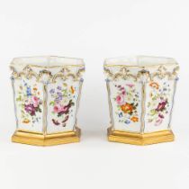 A pair of polychrome and hexagonal porcelain cache-pots with a hand-painted flower decor. (L:18 x W: