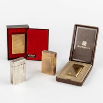 ST. Dupont, Three gold and silver plated lighters, added a Givency lighter. (L:1 x W:3,5 x H:6 cm)