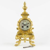 A small gilt bronze mantle clock, enamel dial and decorated with Satyrs. 19th C. (L:15 x W:15,5 x H: