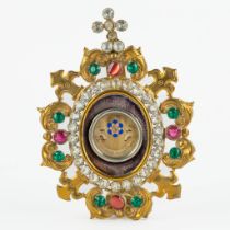 A sealed theca with a relic in a brass holder with glass cabochons, 'Ex Camisia Beata Maria Virginis