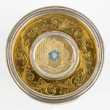 A sealed theca in a relic holder 'Ex Camisia Beata Maria Virginis' with a silver rim. (D:7 cm)