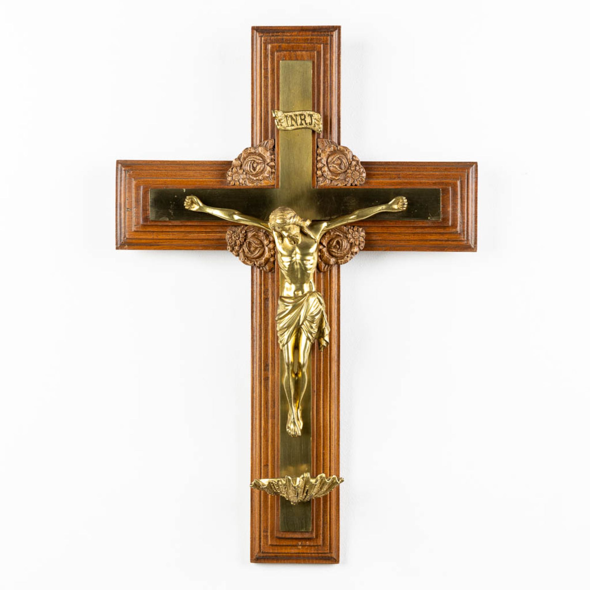 A crucifix with small holy water font, bronze mounted on wood. (W:41 x H:60 cm)