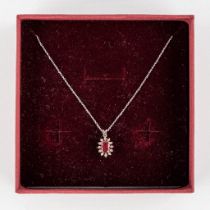 A pendant, 18kt white gold with brilliants and a ruby, on a 14kt white gold necklace. 1,96g.