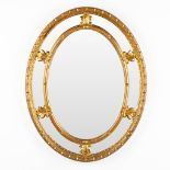 Deknudt, a gilt oval mirror. (W:72 x H:92 cm)