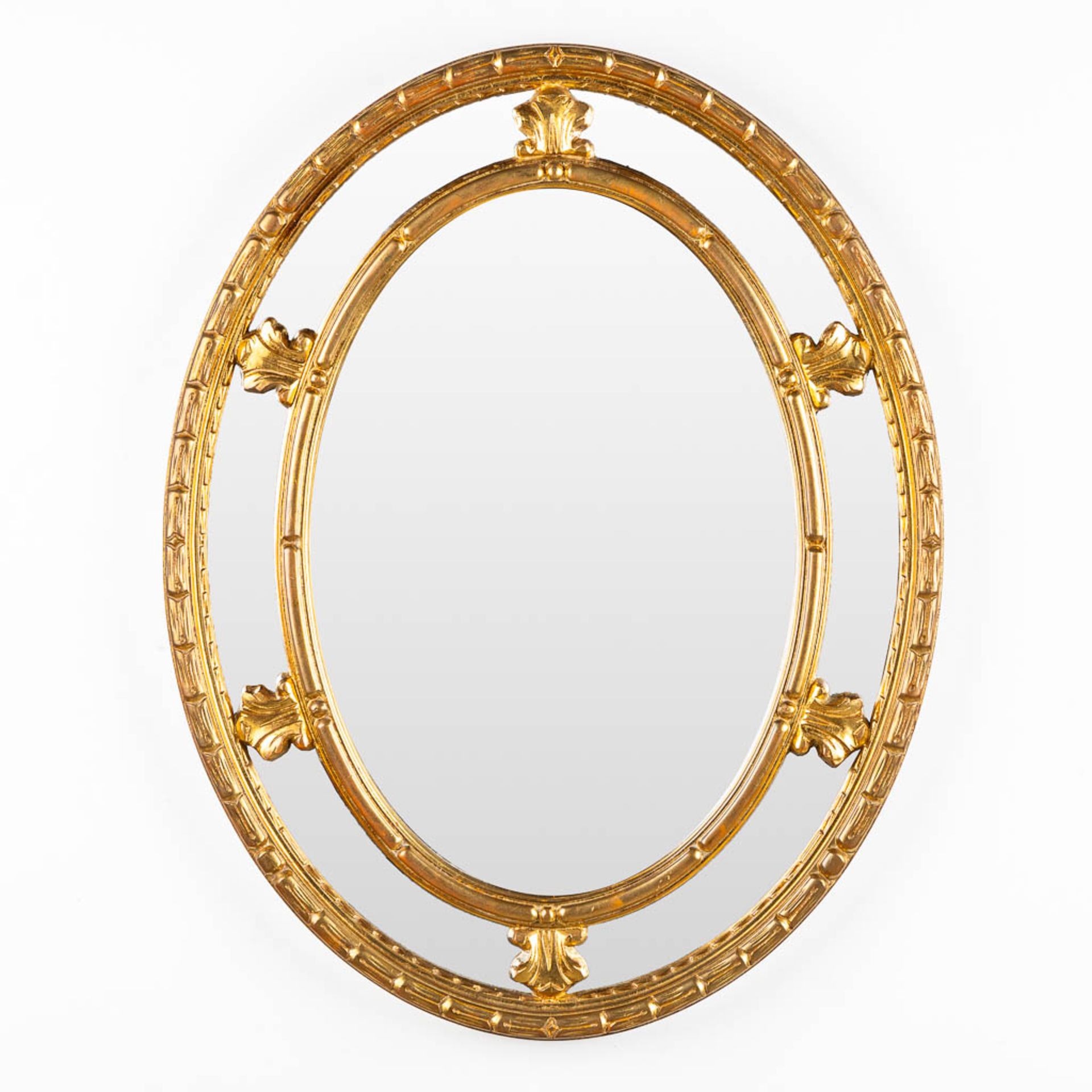 Deknudt, a gilt oval mirror. (W:72 x H:92 cm)
