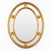 Deknudt, a gilt oval mirror. (W:72 x H:92 cm)