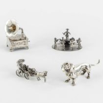 A collection of miniature silver items, a dog, phonograph, orchestra and horse drawn carriage. 311g.