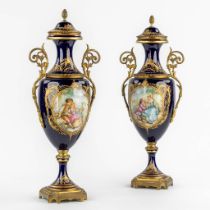 Sèvres, a pair of bronze-mounted and hand-painted cobalt-blue vases. (W:21 x H:53 cm)