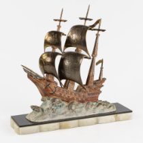 Gallion on the sea' patinated spelter, mounted on onyx. (L:23 x W:72 x H:69 cm)