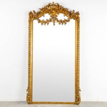 A mirror, sculptured wood, and stucco in a Louis XV style. 20th C. (W:110 x H:218 cm)