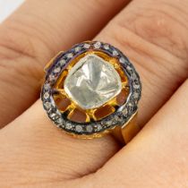 A ring, gilt silver with a large rough cut diamond and small 'old cut' diamonds. 6,38g. Ring size 55