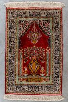 An Oriental hand-made carpet, Silk and wool. (L:102 x W:64 cm)