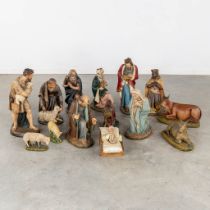 A 14-piece 'Nativity Scène', patinated plaster figurines. Circa 1920. (H:60 cm)
