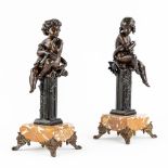 A pair of Children seated on a pedestal, patinated spelter and finished with a small marble. (L:13 x