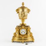 A gilt bronze mantle clock, richly decorated with putti, ram's heads and garlands in Louis XV style.