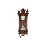 A 19th century oak cased Vienna style wall clock with twin train weight driven movement by Gustav