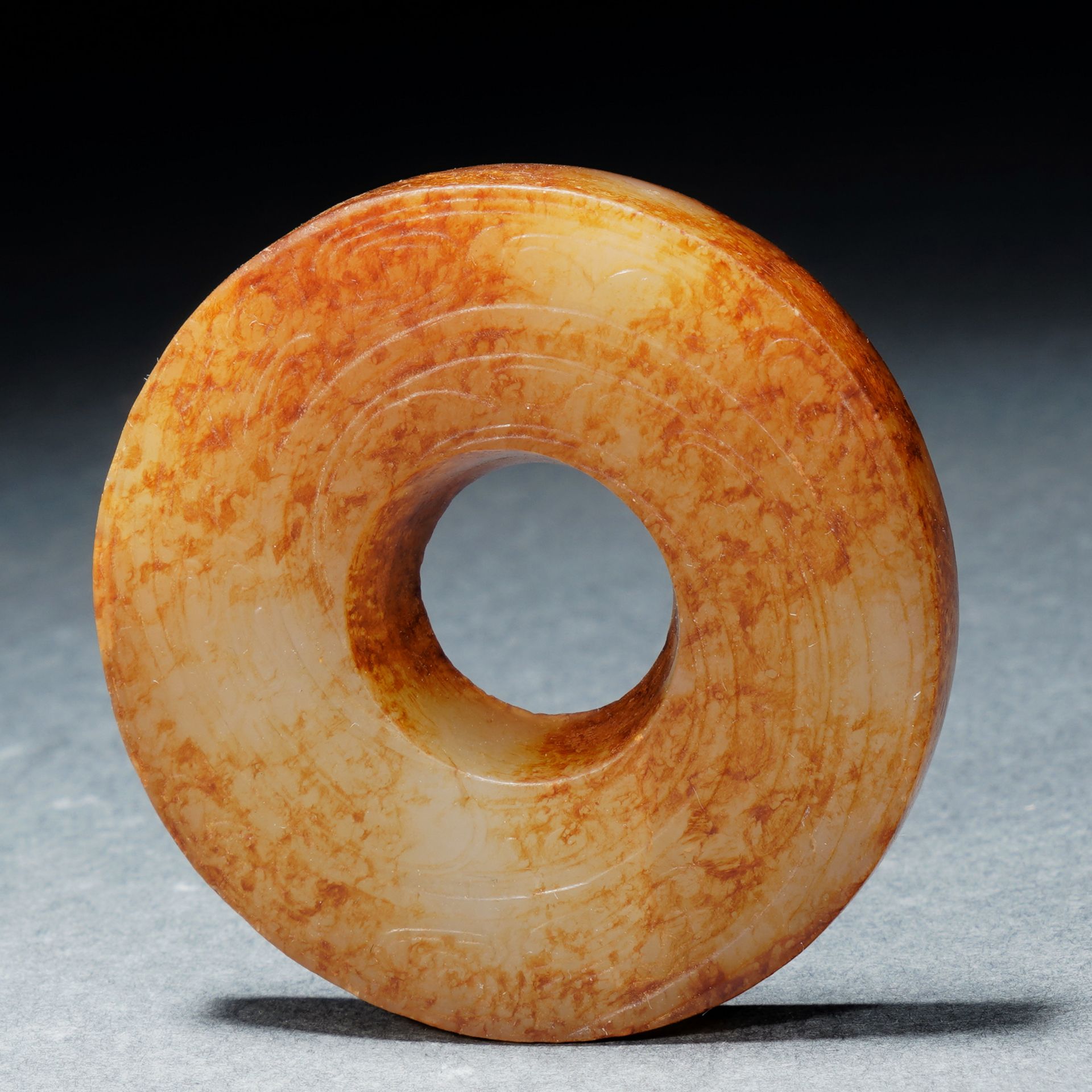 A Chinese Incised Archaistic Jade Disc Bi
