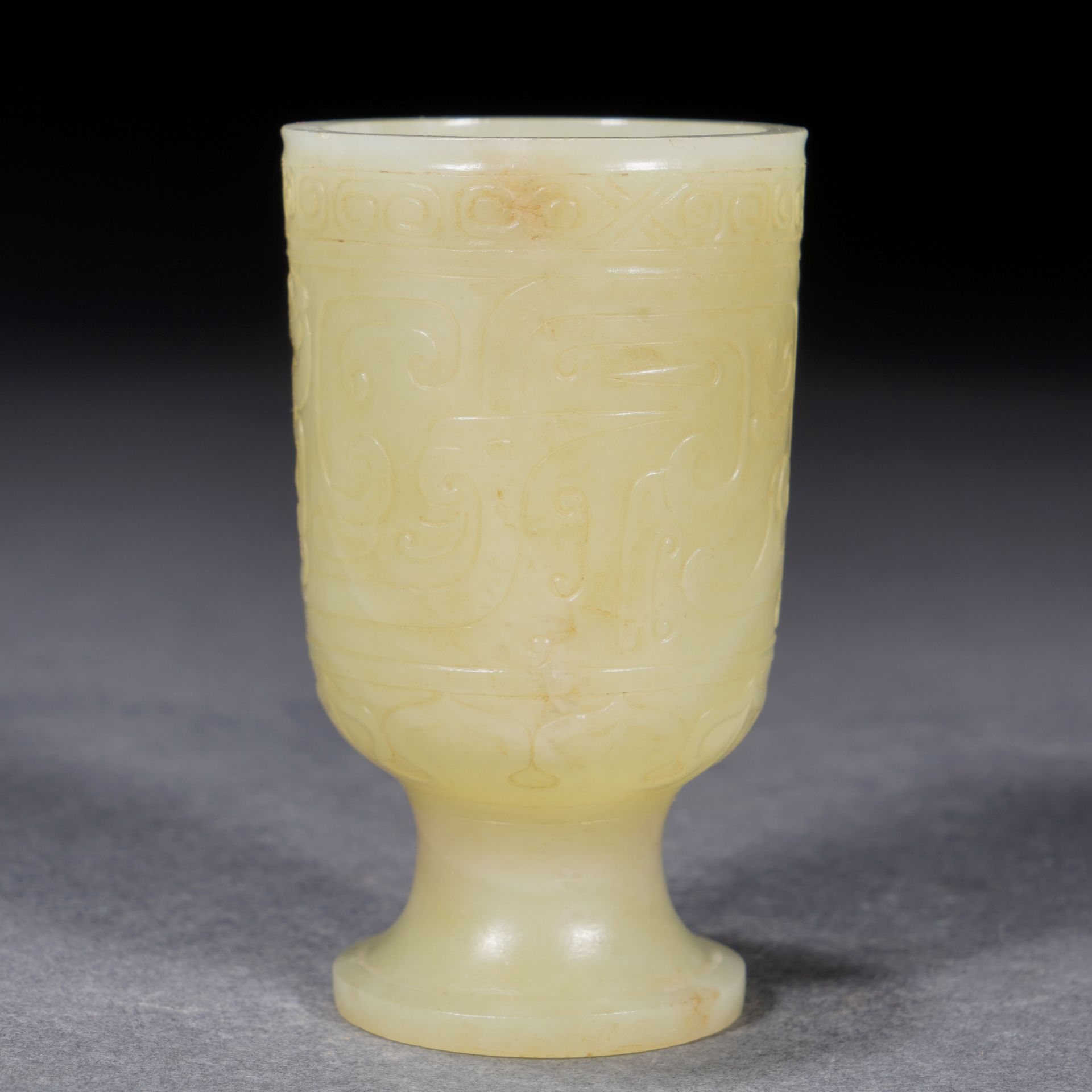 A Chinese Archaistic Carved Yellow Jade Goblet