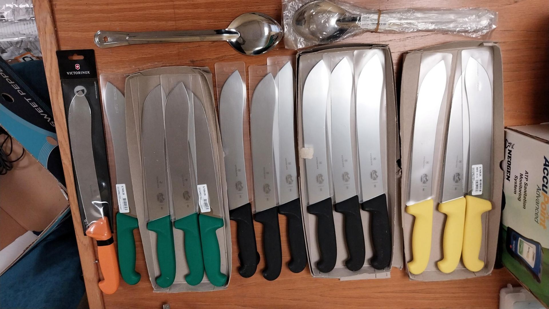 QTY OF VICTORINOX KNIVES AND LARGE SPOONS.