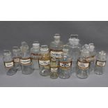 Collection of twelve clear glass apothecary / pharmacy bottles and stoppers with gilt Latin contents