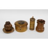 A collection of fruitwood and boxwood items to include an inkwell, castellated dice container,