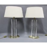 A pair of RV Astley table lamps with clear Perspex type bases with faux brass mounts, complete