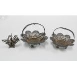 A pair of white metal filigree baskets and a small filigree galleon, 5cm (3)