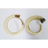 Two Vanuatuan Livatu tusk bracelets, 20th century, each a fully curved boars tusk, one mounted in
