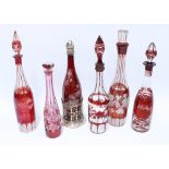 Six various Bohemian ruby flashed glass decanters with stoppers to include one for whisky and one